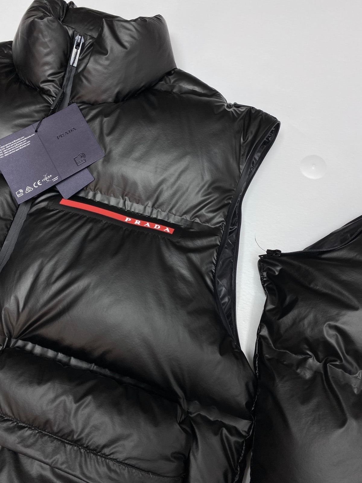 Prada Black Convertible Puffer Jacket with Red Chest Stripe — context